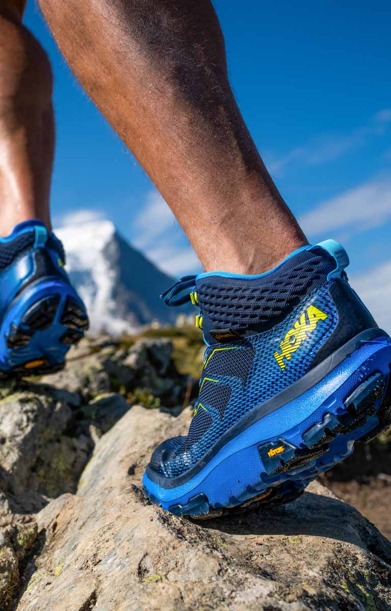 A man hiking on rocks