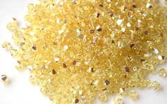 Биконусы 4мм Сваровски Jonquil AB