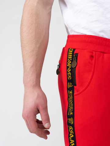 Спортивные штаны красного цвета с лампасами, без манжета. Плотный футер