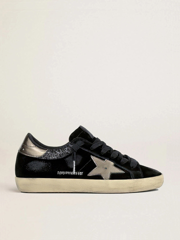Super Star in black suede with gold leather star and heel tab