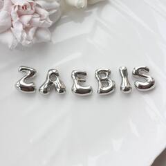 Слово из букв ZAEBIS в серебре