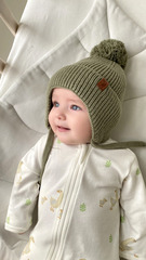 Шапка вязаная на завязках с помпоном (св. хаки)