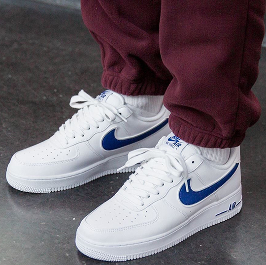 white nike air force 1 with blue swoosh