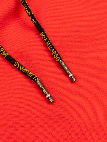 Спортивные штаны красного цвета без манжета, с лампасами. Плотный футер