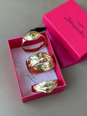 Комлект из трёх жёстких браслетов Schiaparelli