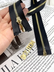 Молния на черной атласной тесьме золотистая