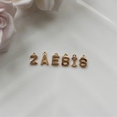 Слово из букв ZAEBIS в позолоте