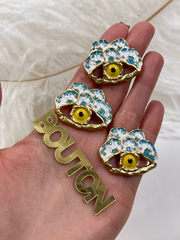 Пуговицы со стразами Скиап. золотистые в форме глаза с белой и бирюзовой эмалью