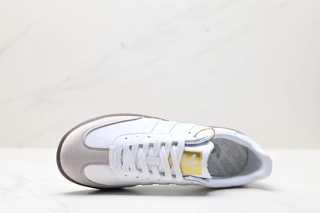 White adidas with yellow stripes on sale