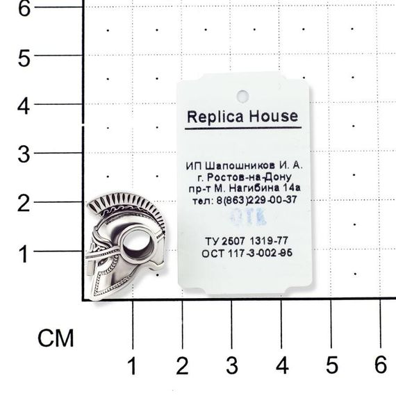 Фотография шарма спартанский шлем, фото на размерной сетке в масштабе с биркой.