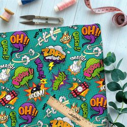 Ткань таффета крупные звуки из комиксов на зелёном фоне