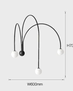 Стильное настенное бра с изящными дугообразными держателями и матовыми шарообразными плафонами.