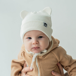 Шапка трикотажная на завязках "Молочный" 0+