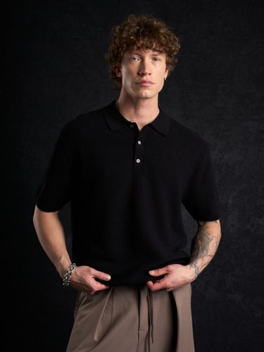 Черная трикотажная футболка-поло Laine New