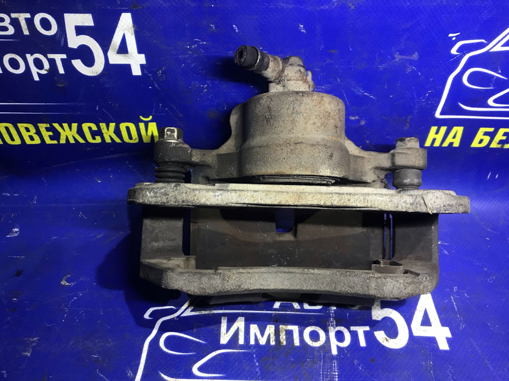 Суппорт тормозной передний левый NISSAN PRESEA 1993
