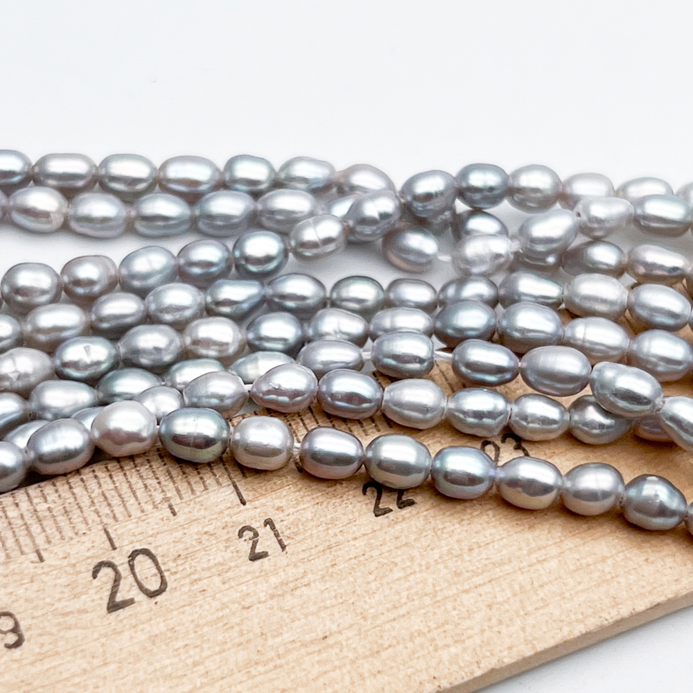 Жемчуг Рис бусины, цвет серый, размер около 4,5-5*3,5-4 мм, цена за отрезок 18 см (1/2 нити)