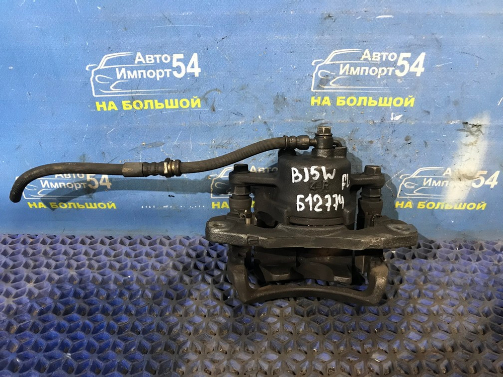 Суппорт тормозной передний левый MAZDA FAMILIA 1998-2003