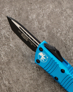 Автоматический складной нож Microtech Mini Troodon Black Tanto 240-1BL (голубой) фронталка/выкидуха
