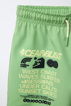 ZARA ПЛАВКИ КЛАССИЧЕСКОГО КРОЯ С НАДПИСЬЮ, ХАКИ