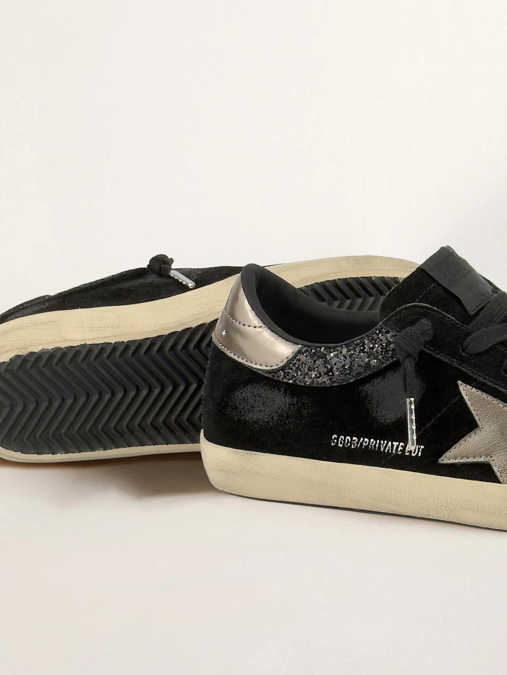 Super Star in black suede with gold leather star and heel tab