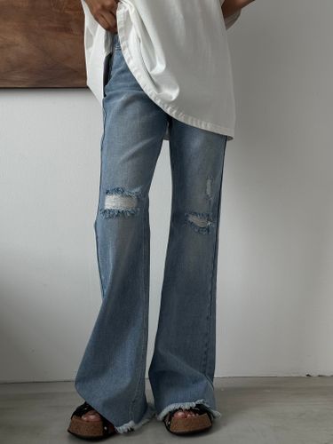 Синие рваные джинсы-клеш