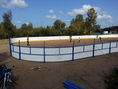 Хоккейный корт обшитый листами из ламинированной фанеры, сетка рабица за воротами