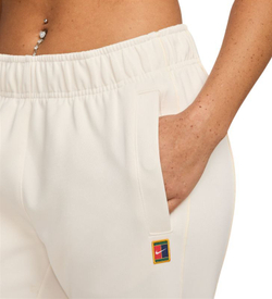 Женские теннисные брюки Nike Court Heritage Windrunner Mid-Rise Tennis - бледно-слоновая кость