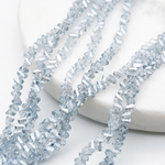 Бусина Треугольник, стекло, цвет голубой АВ, размер около 2,5*3,5 мм, цена за нить 26 см