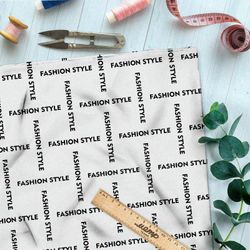 Ткань саржа стильная клетка из чёрных надписей на бежевом фоне