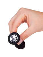 Чёрная анальная втулка с прозрачным кристаллом - 7,3 см.