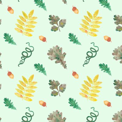 Осенние листья с желудями на зеленом фоне