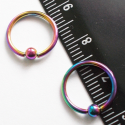Кольцо сегментное 1,2мм (бензинка), диаметр 10 мм, шарик 3 мм для пирсинга. Медицинская сталь, покрытие титан. 1 шт