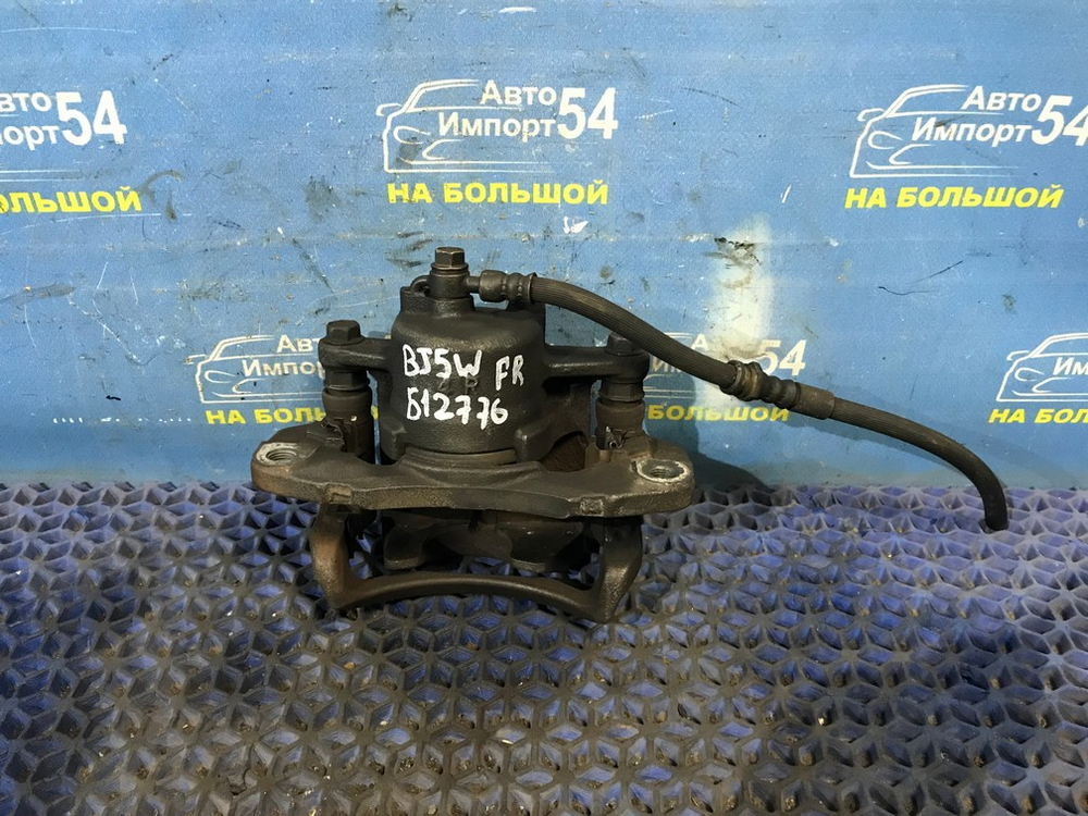 Суппорт тормозной передний правый MAZDA FAMILIA 1998-2003