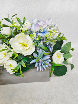 Композиция Мечта из искусственных цветов в длинном светлом кашпо