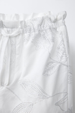Shiny embroidered trousers