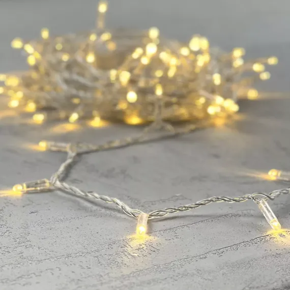 Светодиодная гирлянда с колпачком 100 теплых белых LED ламп 10 м., 24В., прозрачный провод ПВХ, IP65, LTC (PST100CAP-10-1WW)