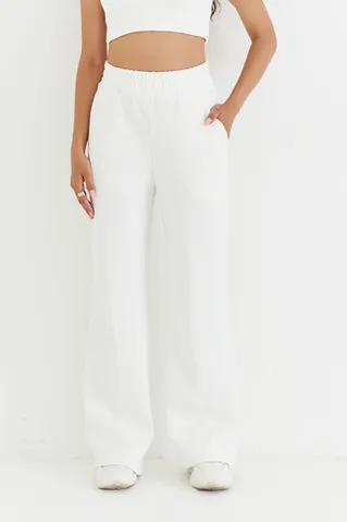 Брюки клеш из премиум футера кремового цвета