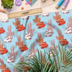 Ткань штапель золотые и белые рыбки на голубом фоне