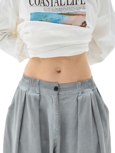 Серые хлопковые брюки-бананы с защипами