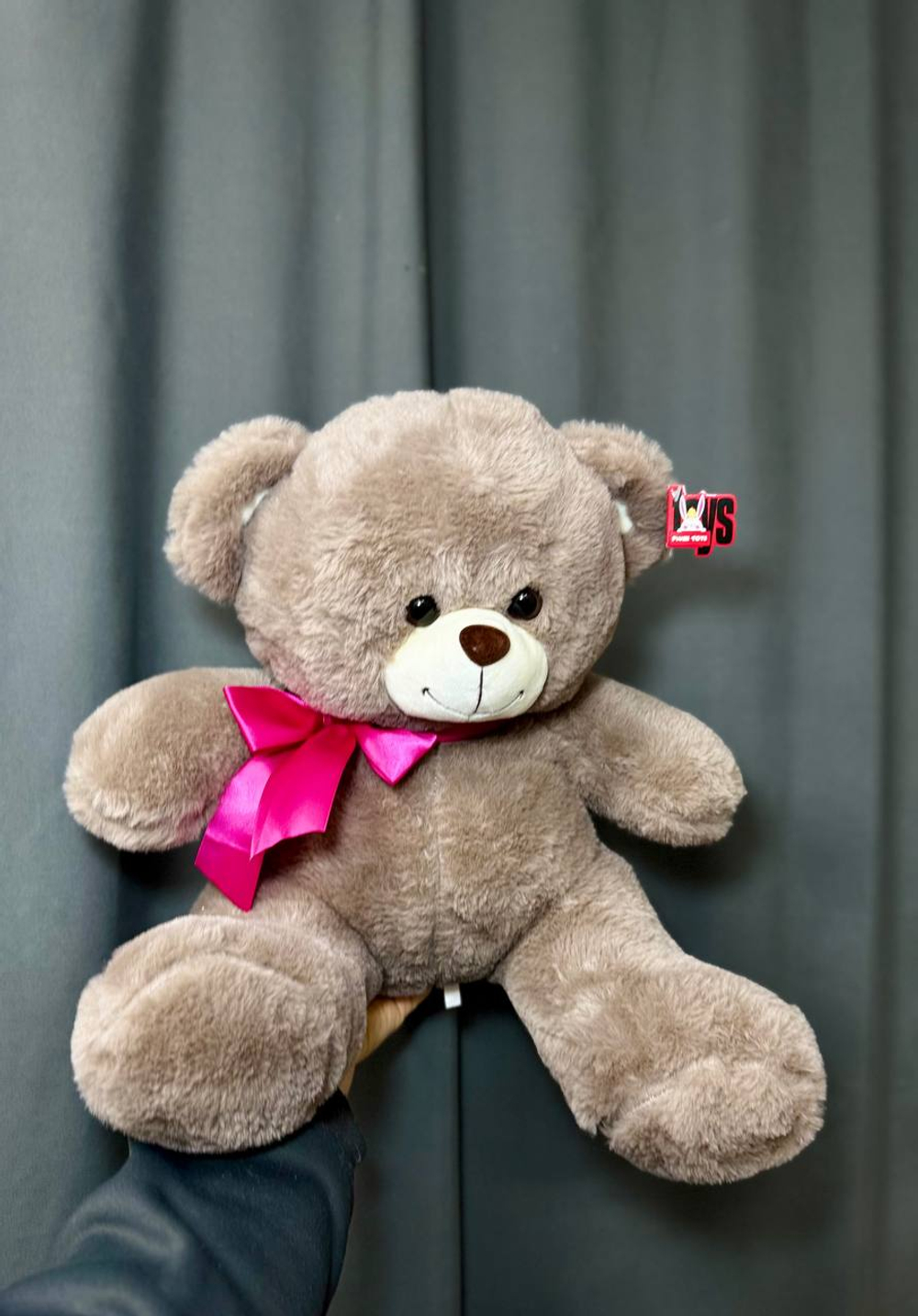 Коричневый мишка с розовым бантом