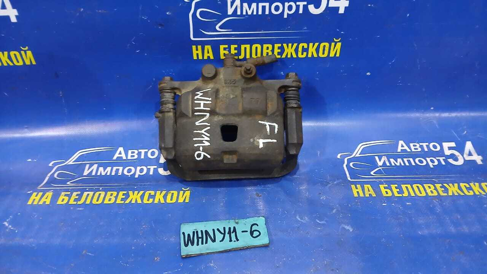 Суппорт тормозной передний левый NISSAN WINGROAD 1999