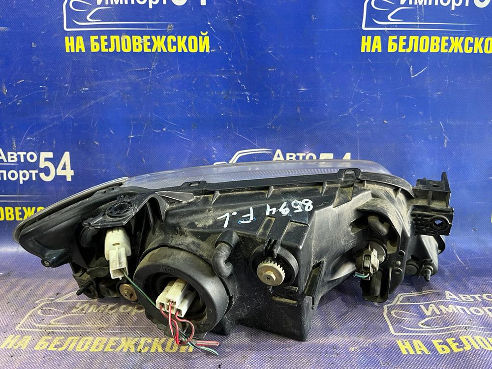 Фара передняя левая MAZDA FAMILIA 2000-2003