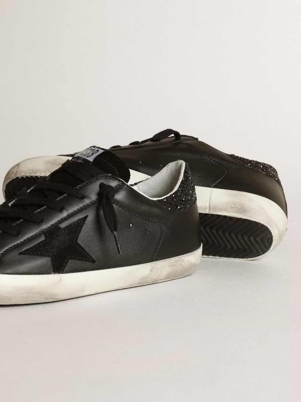 Super Star in black nappa with black star and glitter heel tab