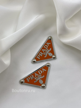 Логотип металлический Прад. серебро с оранжевым
