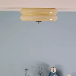 Потолочный светильник с гладким стеклянным плафоном кремового оттенка.