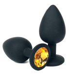 Черная силиконовая анальная пробка с оранжевым стразом - 6,8 см. (Цвет: оранжевый)