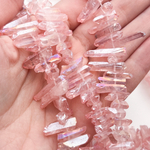 Кварц тонированный необработанные бусины, цвет темно-розовый, размер около 15-25*4-6 мм, цена за отрезок 9,5 см (1/4 нити)