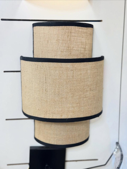 Стильное настенное бра с многоуровневым абажуром из натурального текстиля.