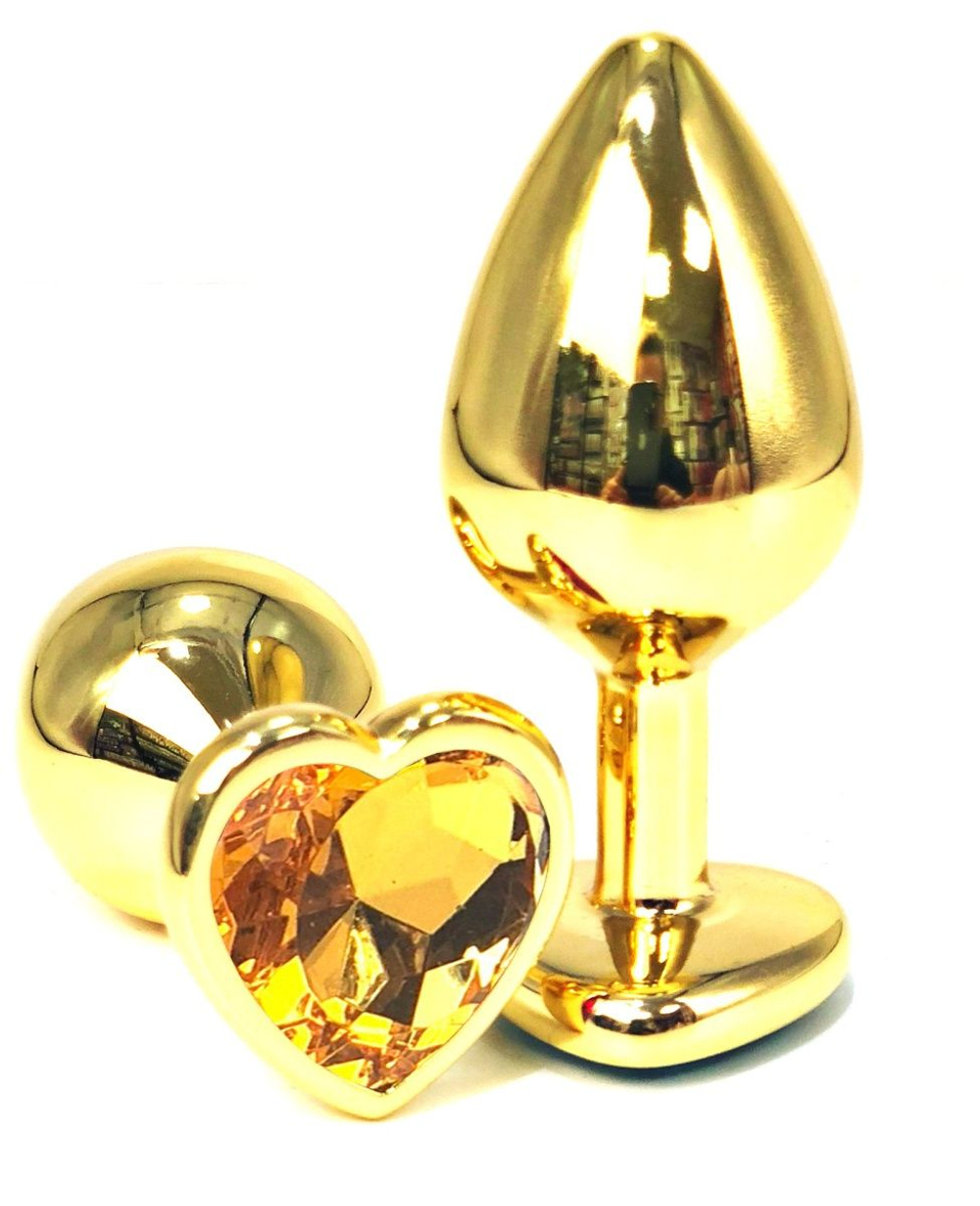 Золотистая анальная пробка с оранжевым кристаллом-сердцем - 7 см. (Цвет: оранжевый)