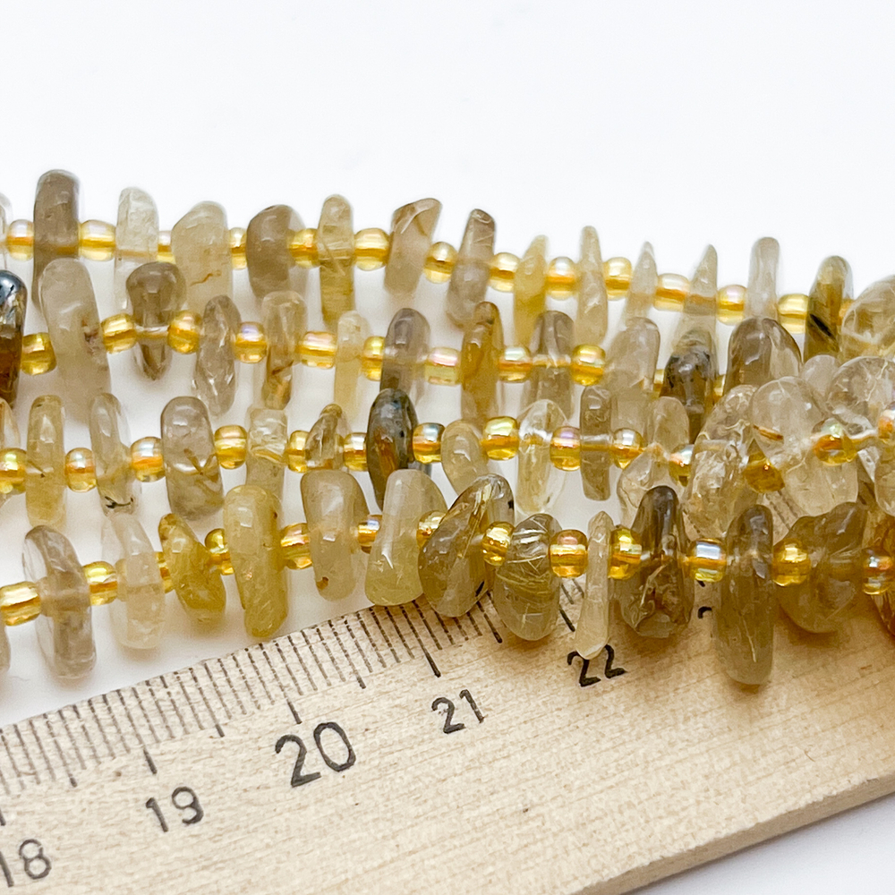 Кварц рутиловый бусины, галтовка, размер около 8,5-11*2-4 мм, цена за отрезок 19 см (1/2 нити)